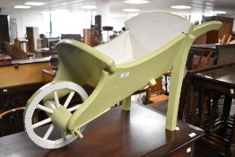 A painted wooden decorative barrow of small proportions