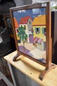 A traditional fire screen having feltwork pictorial panel