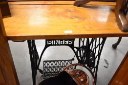 A rustic plank top dining table, on sewing machine stand, approx top size 151 x 69cm