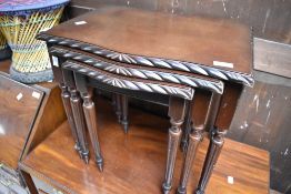 A reproduction nest of three mahogany effect occasional tables