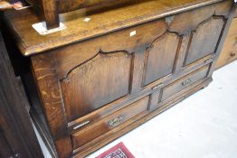 A Titchmarsh and Goodwin or similar nice quality reproduction oak kist style TV cabinet having