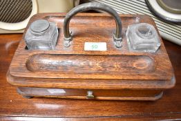 A late 19th or early 20th Century oak ink stand
