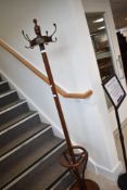 An Oriental hardwood hat stand , having turned finial and bentwood supports, on platform base,