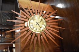 A vintage 'starburst' clock, dial named for Ainstey and Wilson