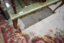 An Onyx effect coffee table having gilt foliate legs, approx. 92 x 45cm
