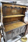 A reproduction oak dresser of small proportions, width approx. 93cm, height approx. 148cm