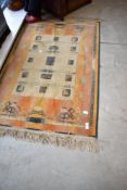 A traditional silk rug/wall hanging, in shades of orange, approx. 105 x 70cm