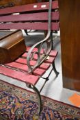 A vintage slatted garden bench having metal supports, width approx. 122cm