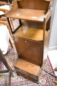 An early 20th Century oak metamorphic work table by Waring & Gillow