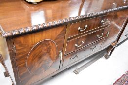 An early 20th Century mahogan sideboard having gadrooned decoration and ball and claw feet, width