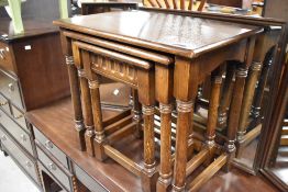 A Priory style oak nest of three tables