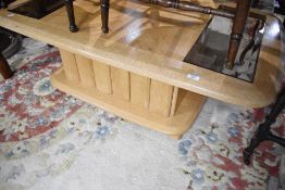 A modern coffee table having parque style and smoked glass top, approx. 127 x 75cm