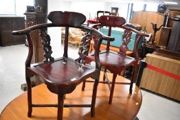 A pair of Oriental hardwood corner chairs
