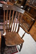 A traditional dark stained railback carver chair on turned frame
