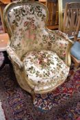 A French style gilt wood armchair having floral upholstery
