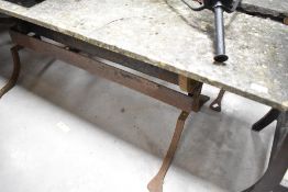A stone topped garden low table , having wrought iron supports
