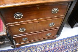 A 19th Century mahogany chest of three long drawers, having Regency style handles and bracket