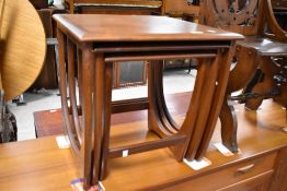 A vintage teak nest of three stylised tables in the G Plan Astro style