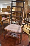 A Victorian stained frame ladder back armchair having upholstered seat