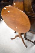 A Victorian mahogany snap top table having circular top turned column and triple splay legs,