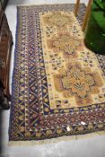 A Kazak style wool rug, having blue and cream ground, approx. 190 x 107cm