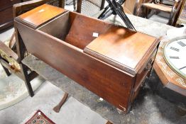 A Victorian mahogany composite storage book having central lidded compartment and drawers to end,
