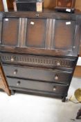 A dark stained Priory style bureau