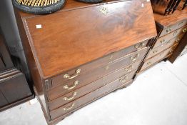 A 19th Century Georgian mahogany bureau , having brass drop handles and fitted interior, width