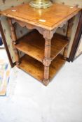A reproduction oak occasional table, in the Titchmarsh and Goodwin style, with plank shelves,