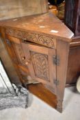 A Priory style oak corner cupboard , approx height 97cm