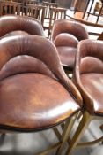 A set of four modern brown leather bar stools