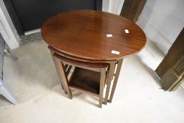 An early 20th Century mahogany nest of three oval tables