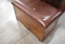 A stained frame storage box having studded leather upholstered seat, width approx. 95cm