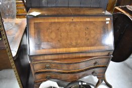 An early to mid 20th Century walnut bureau having serpentine drawer base, width approx. 76cm