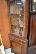 A reproduction corner display cabinet