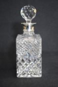 An Elizabeth II silver mounted cut glass decanter, of rectangular form having a silver mount and