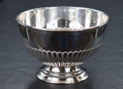 An Edwardian silver pedestal bowl, of circular form having a moulded rim and half gadrooned body,