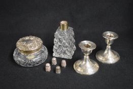 A pair of late Edwardian silver candlesticks, of traditional form having step moulding decoration,