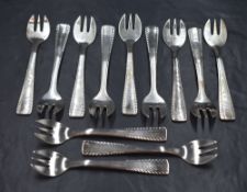 A cased set of twelve French white metal cake forks, believed to be silver plated, having decorative