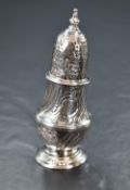 A late George II silver pepperette, of traditional bulbous form having decorative floral and