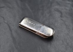 An Elizabeth II silver money clip, of traditional form having a flying kite engraving, marks for