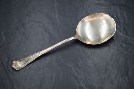 A George VI silver Hanoverian style serving spoon, having an angular terminal and large shallow