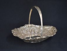 A late Victorian silver fruit bowl, of oval form having a handle with thread and embossed foliage