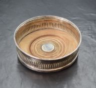 A Georgian silver wine coaster, of circular form having a gadrooned style rim, half gadrooned