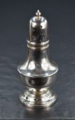 A George V silver pepperette, of of bulbous form having finial top with moulding decoration,