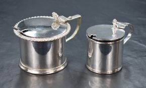 An Edwardian silver mustard, having a gadrooned rim and step moulded base with condiment spoon and