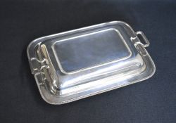 A George V silver serving dish, of rectangular form having egg and dart rims to the body and lid