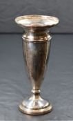 An Elizabeth II silver fluted vase, having a slightly flared rim with moulded decoration, raised
