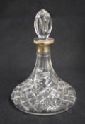 A late 20th century silver mounted cut glass decanter, of bulbous form having an elongated neck with