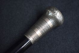 A George V silver mounted walking stick, the pommel having engine turned decoration to the